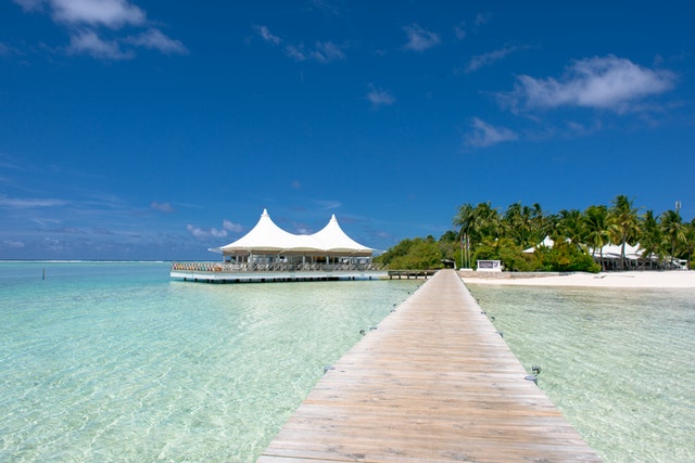 beach dock near hut under blue skies 1724437
