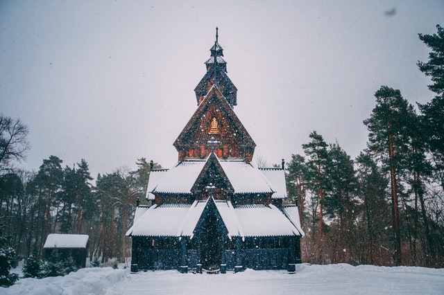 snow covered house beside trees 2299554