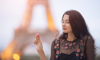 paris woman smiling eating the french pastry macar 2021 08 28 23 14 41 utc 2