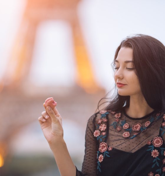 paris woman smiling eating the french pastry macar 2021 08 28 23 14 41 utc 2