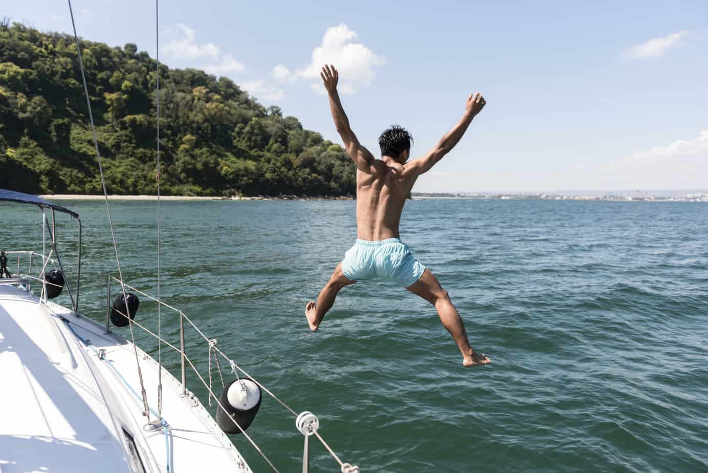 handsome young man enjoying time boat scaled